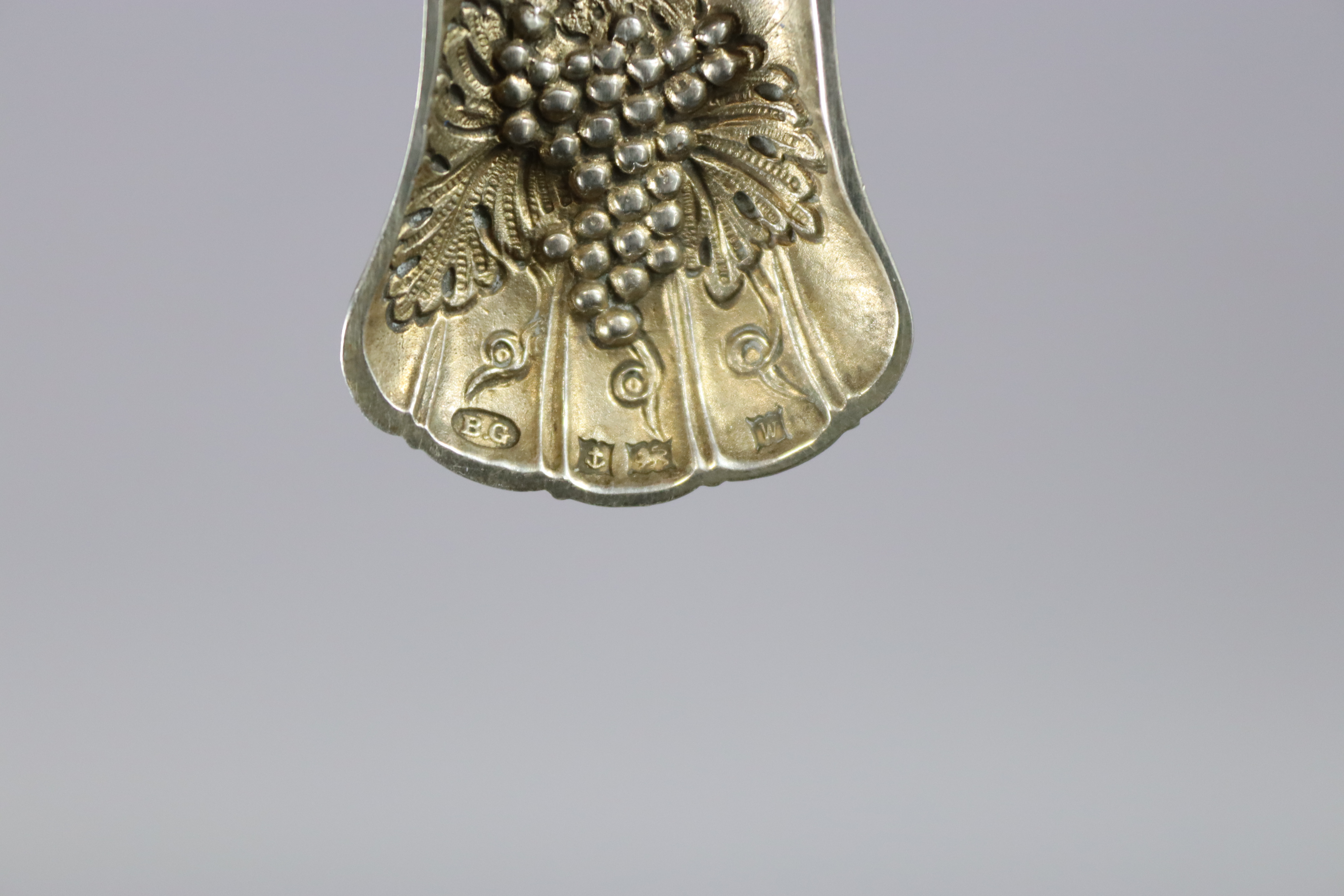An Elizabeth II silver caddy spoon with a pierced foliate handle, & with raised grapevine design - Image 2 of 3
