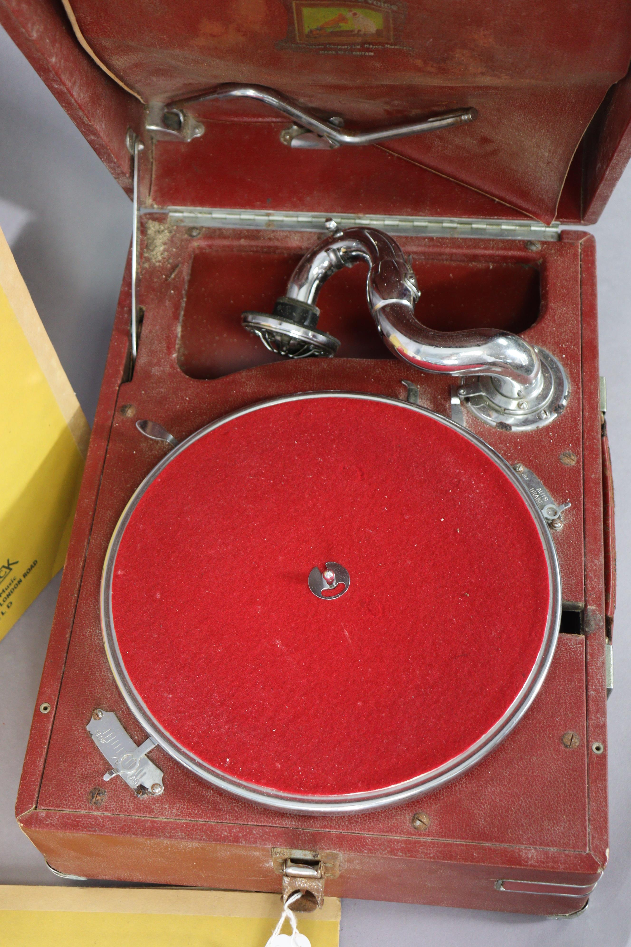 A vintage HMV portable gramophone in a red fibre-covered case; & six 78 r.p.m. records. - Image 4 of 9