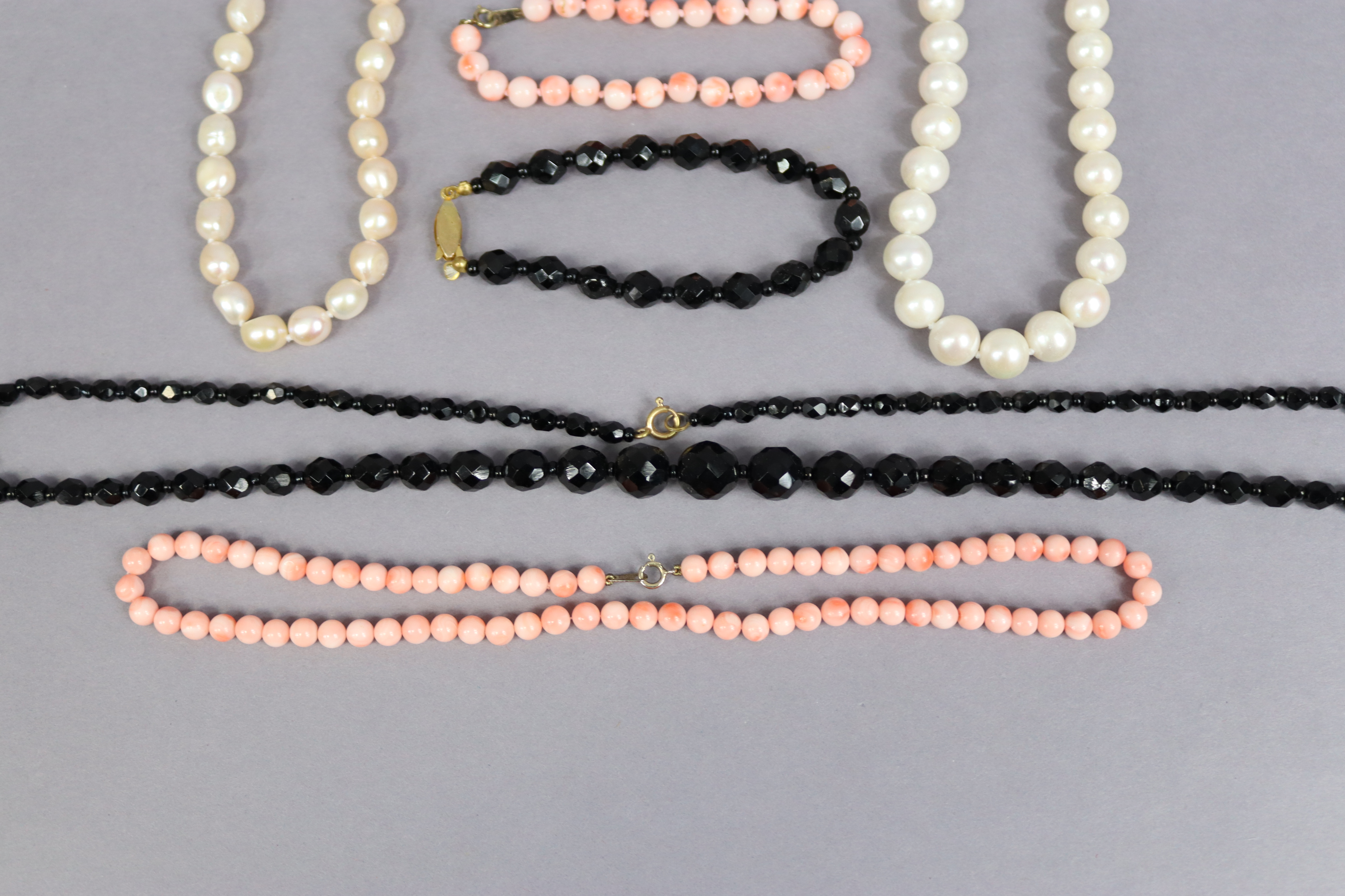 Two pearl necklaces, 43cm & 42.5cm long; a coral necklace, 40cm long; a jet necklace, 60cm long, - Image 4 of 4