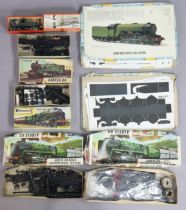 Three Airfix train model kits, together with two other model kits, all boxed.
