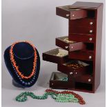 A collection of various bead necklaces including coral, turquoise, malachite, etc., contained in a