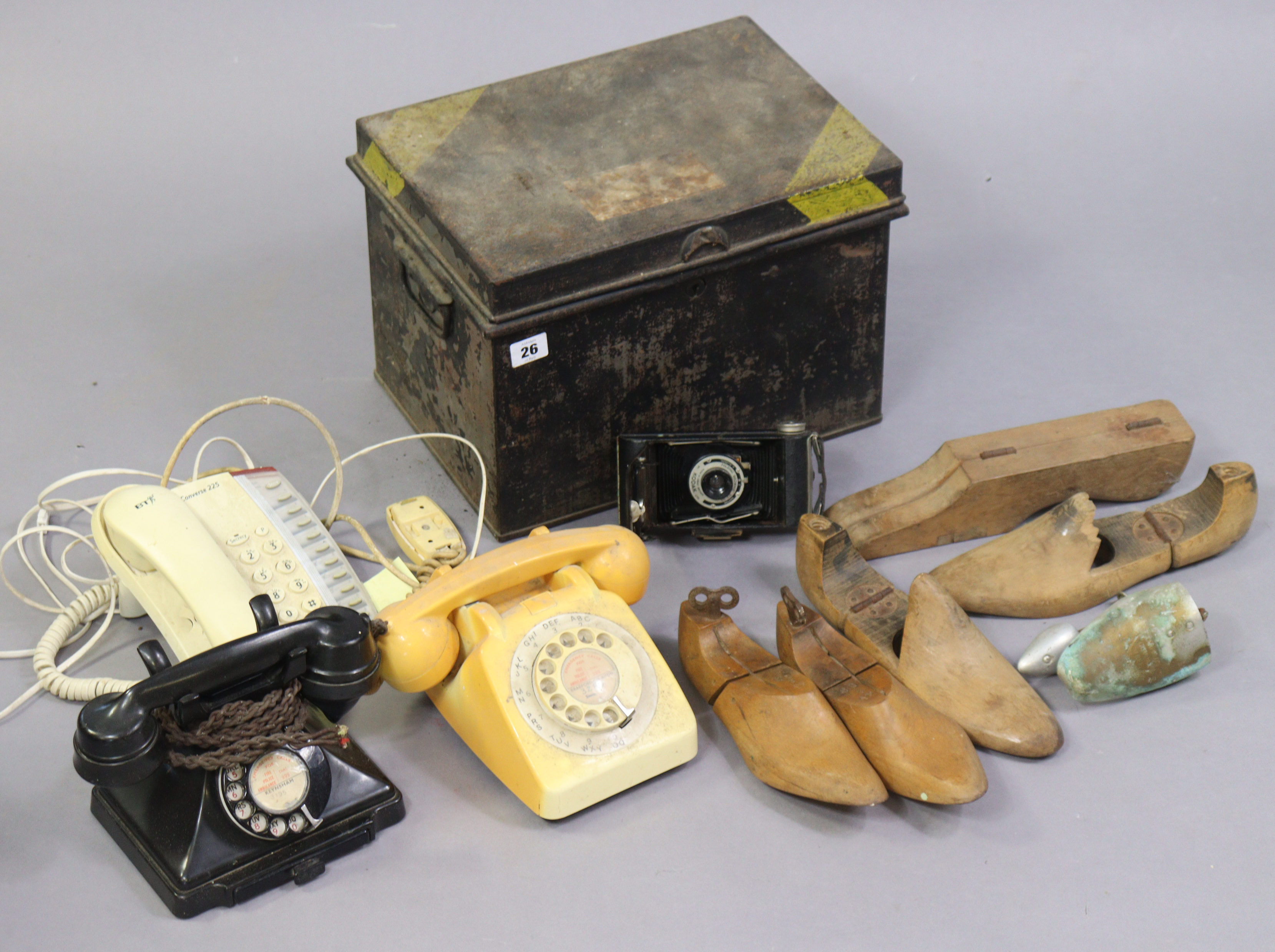 A vintage G.P.O. black Bakelite telephone; together with two other telephones; a Kodak Brownie six-