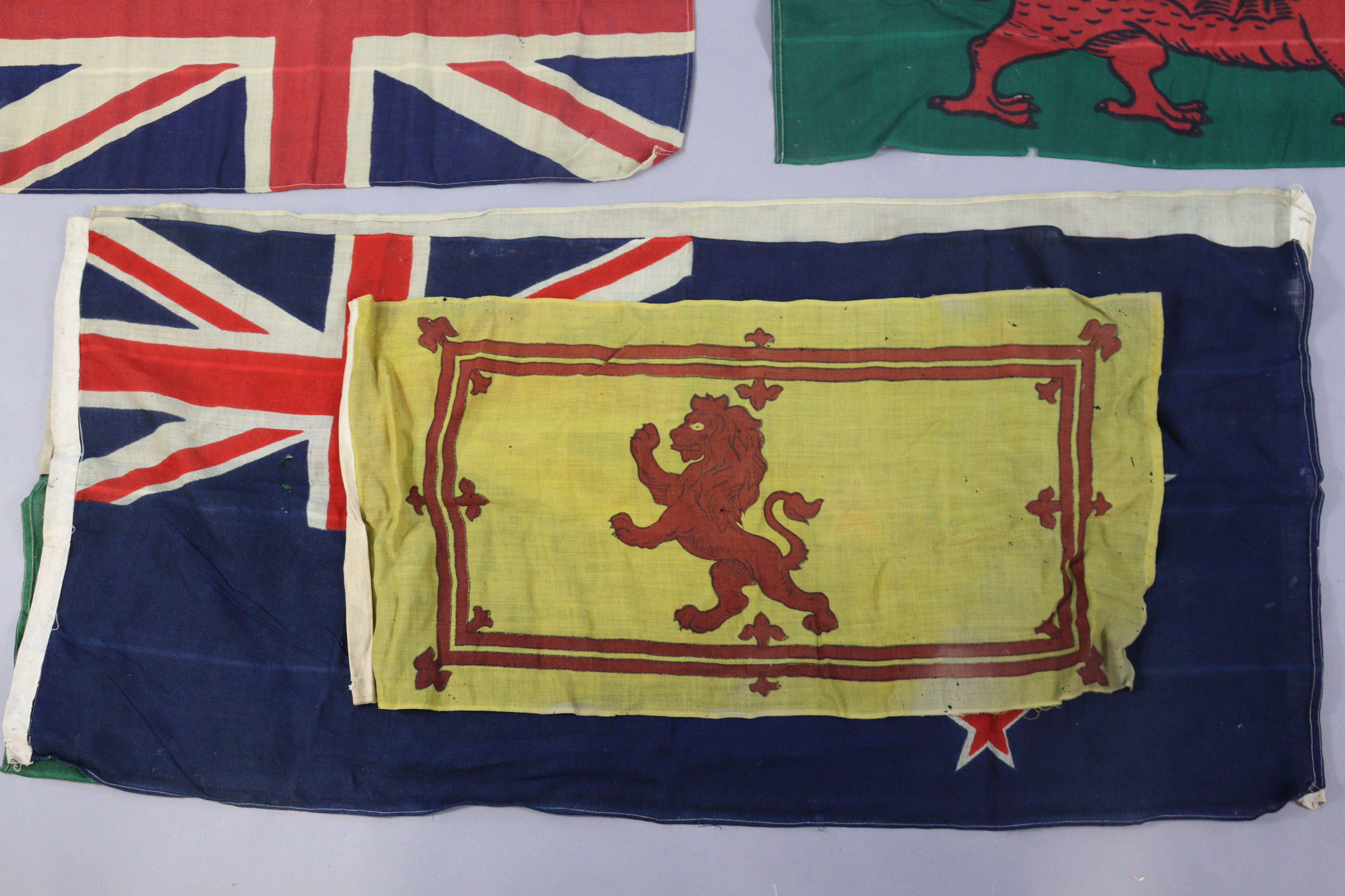 A vintage leather cartridge belt with a brass buckle, 117cm long; together with six various flags. - Image 4 of 4