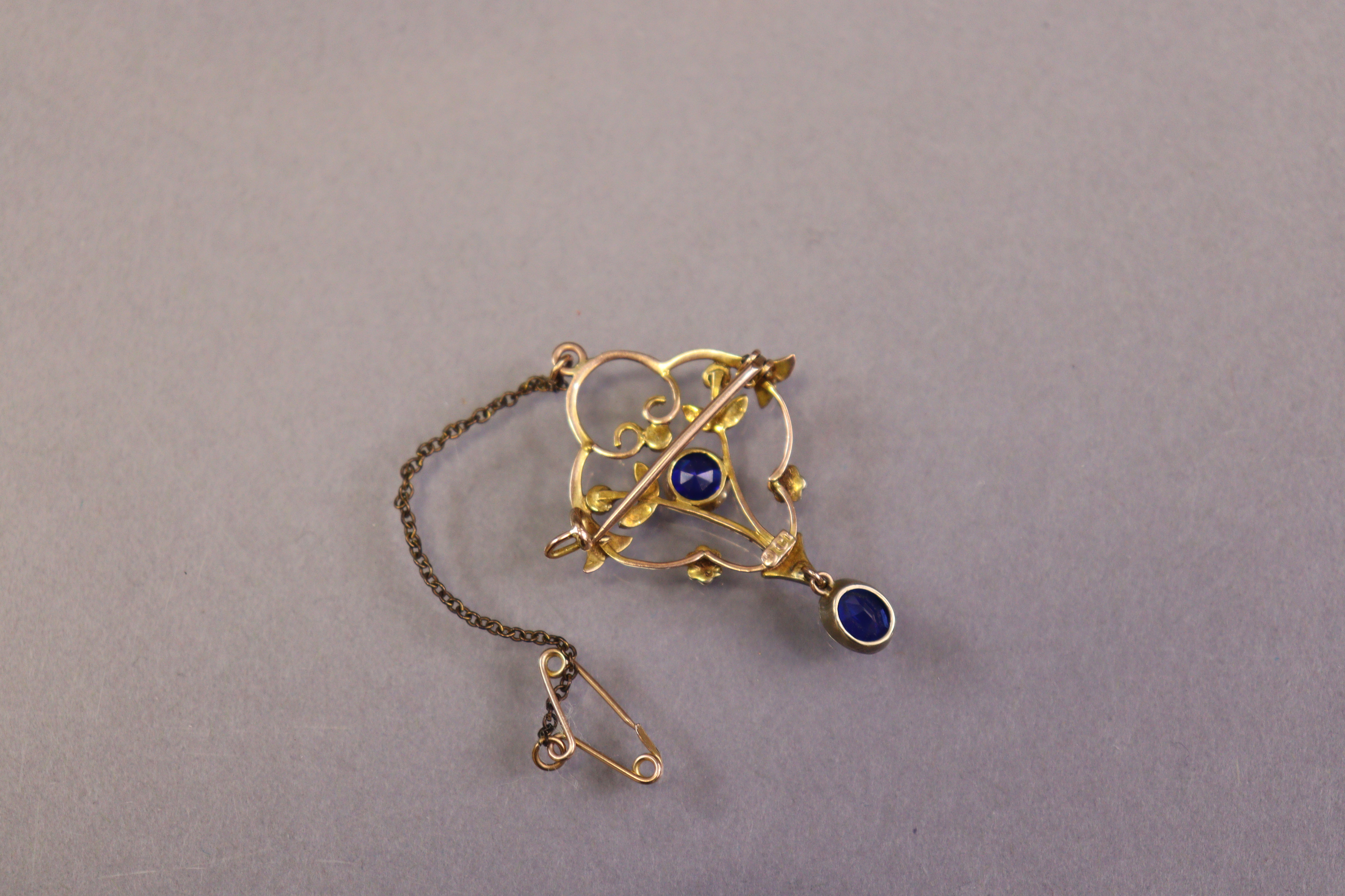 An early 20th century 9ct gold openwork brooch set round-cut sapphire & seed pearls, an oval-cut - Image 2 of 2