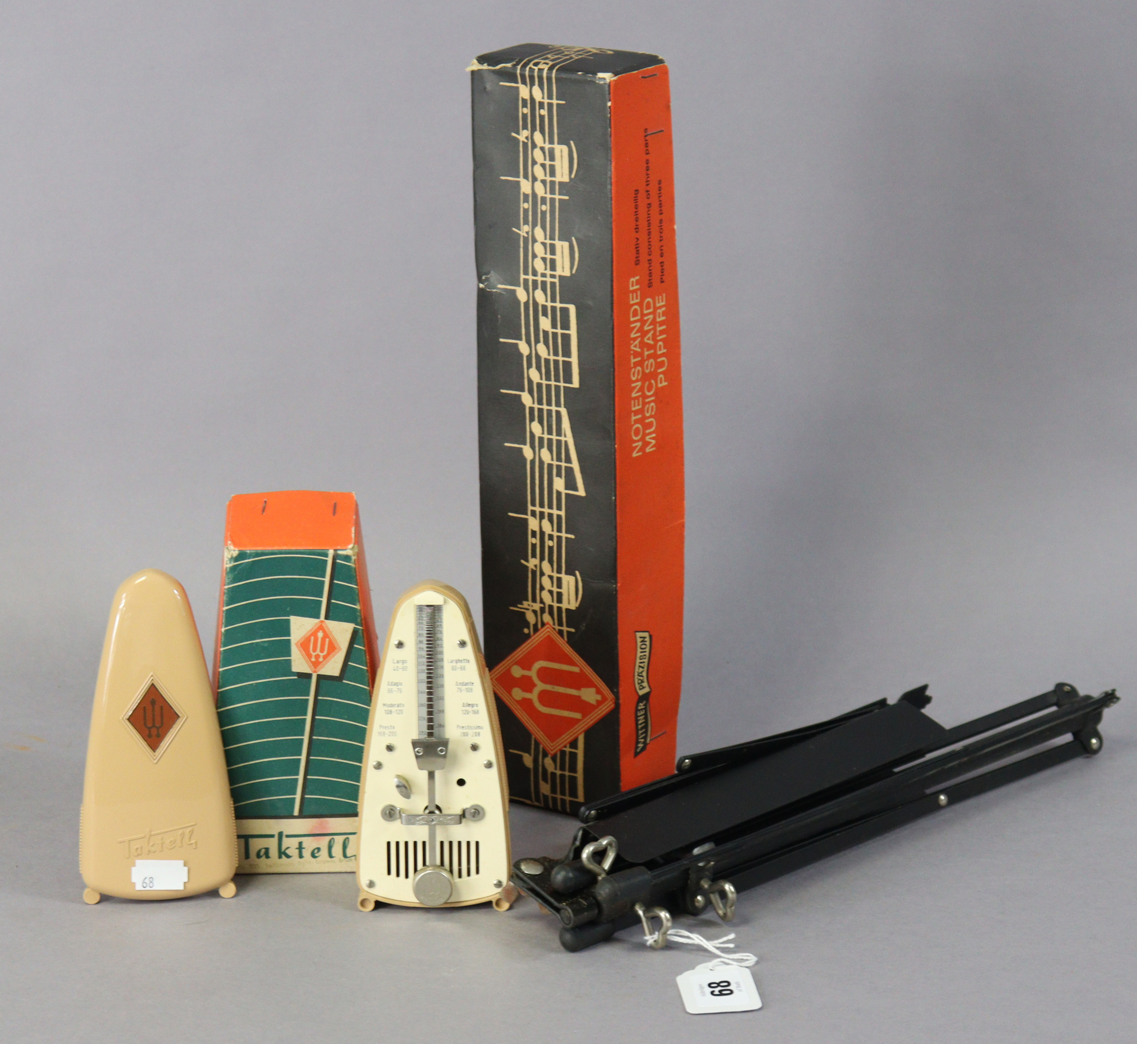 A Taktell (German) metronome; and a Witther sheet music stand, both boxed.