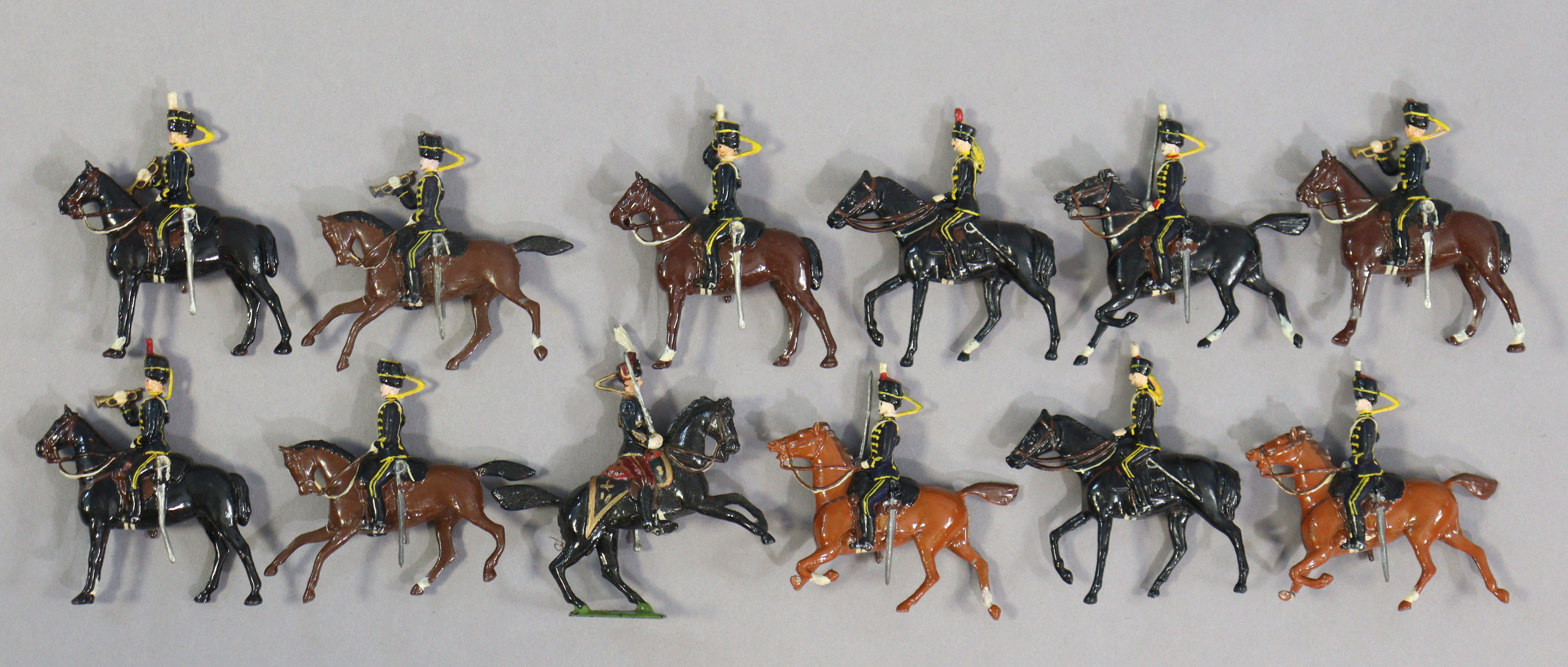 Twelve Britain’s painted lead equestrian soldier figures.