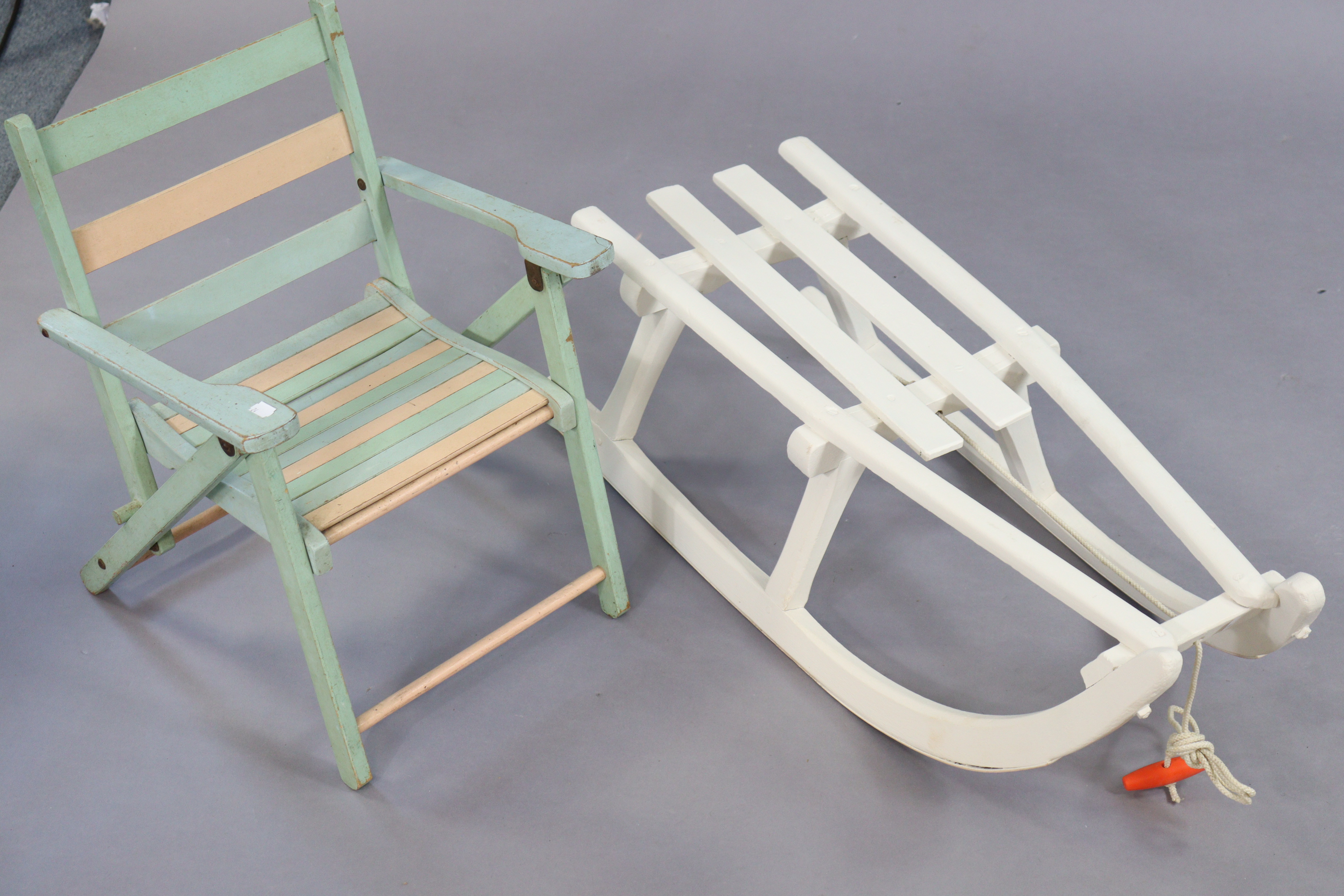 A white painted wooden child’s sledge, 83cm long, and a child’s fold-away chair. - Image 2 of 2
