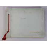 A WWII photograph album containing numerous photographs, postcards, & ephemera all relating to R.A.