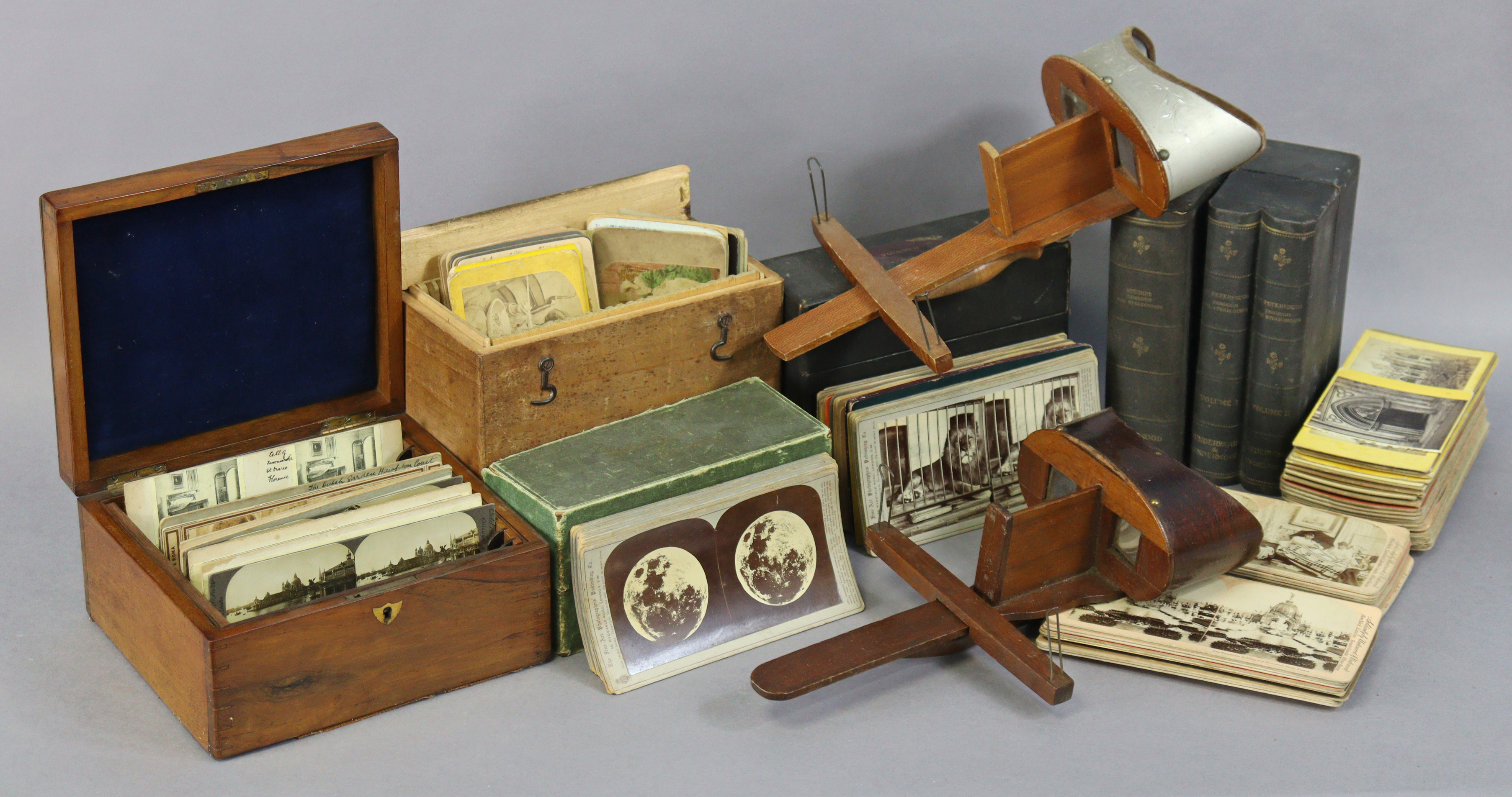 Two vintage wooden stereo-card viewers, and various stereo-view cards, and card boxes.