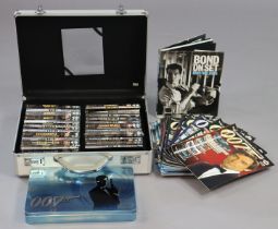 Twenty various James Bond DVDs; a set of 007 spy cards, both cased; & various James Bond books &