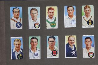 A vintage album of mixed cigarette cards including a set of Mitchell’s “Our Empire” cards; a set