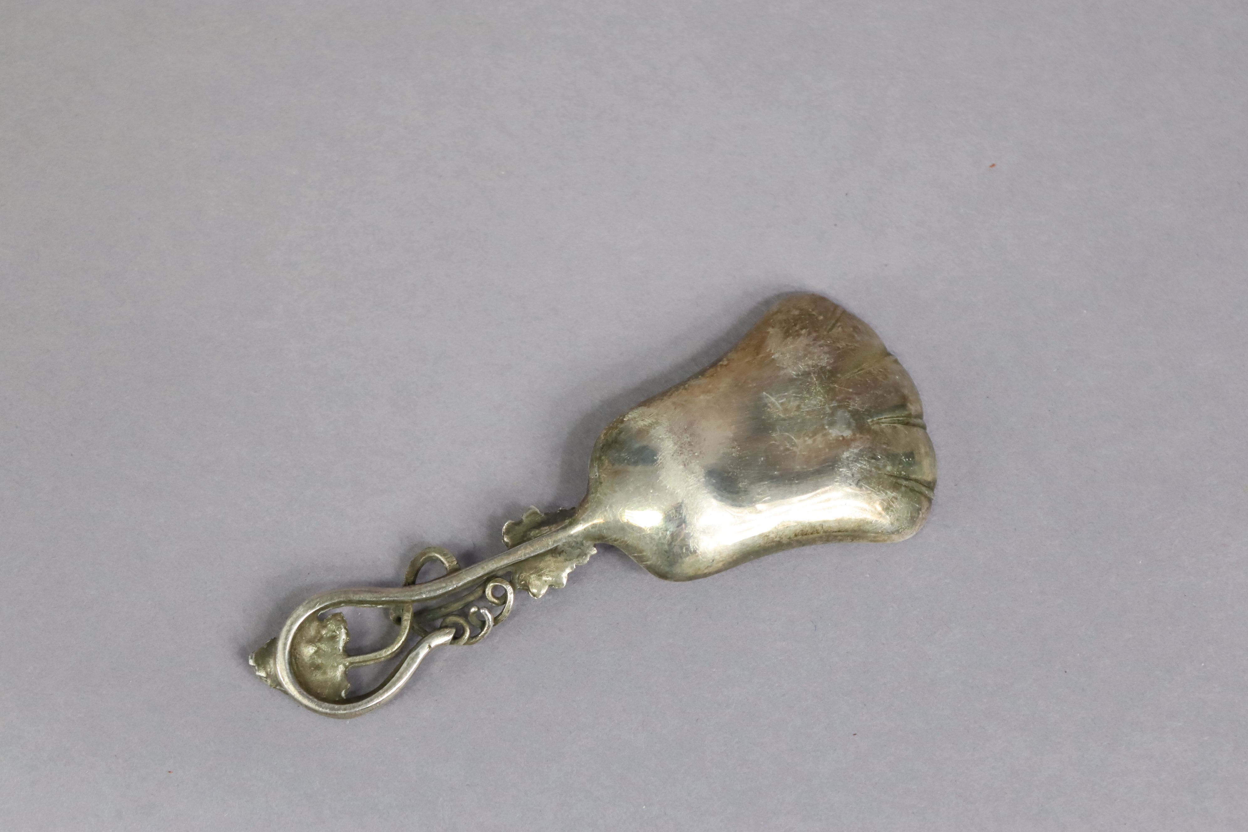 An Elizabeth II silver caddy spoon with a pierced foliate handle, & with raised grapevine design - Image 3 of 3
