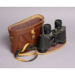 A pair of French black lacquered field glasses with case.