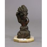 A bronzed Indian chief’s bust sculpture mounted on an onyx octagonal plinth, 22cm high.