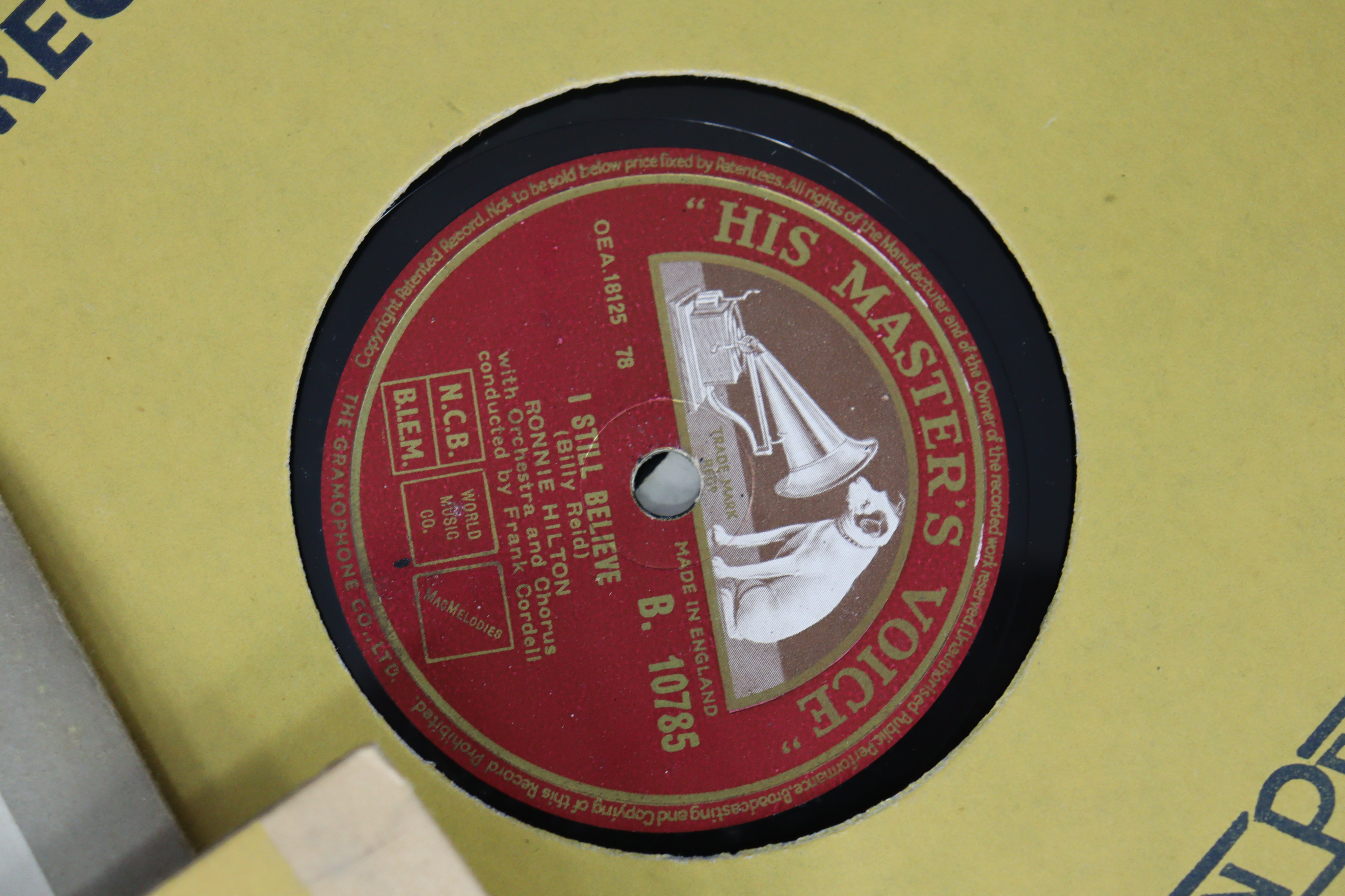 A vintage HMV portable gramophone in a red fibre-covered case; & six 78 r.p.m. records. - Image 7 of 9