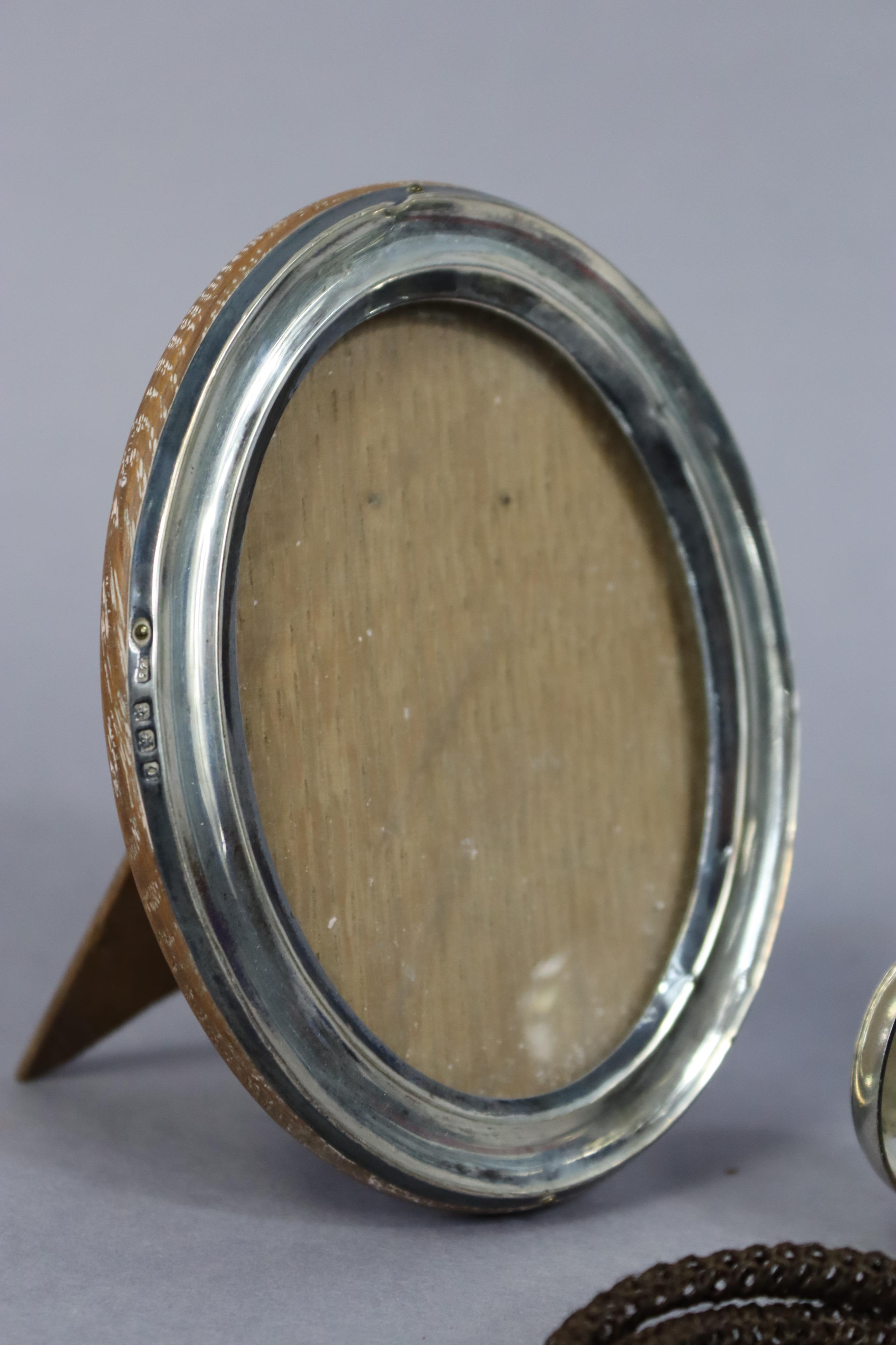 A late Victorian silver sovereign case, Birmingham 1900; a silver oval photograph frame; a silver- - Image 5 of 5