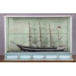 A late 19th/early 20th century DISPLAY OF A PAINTED WOODEN BRITISH SAILING VESSEL BUILT BY JOSEPH