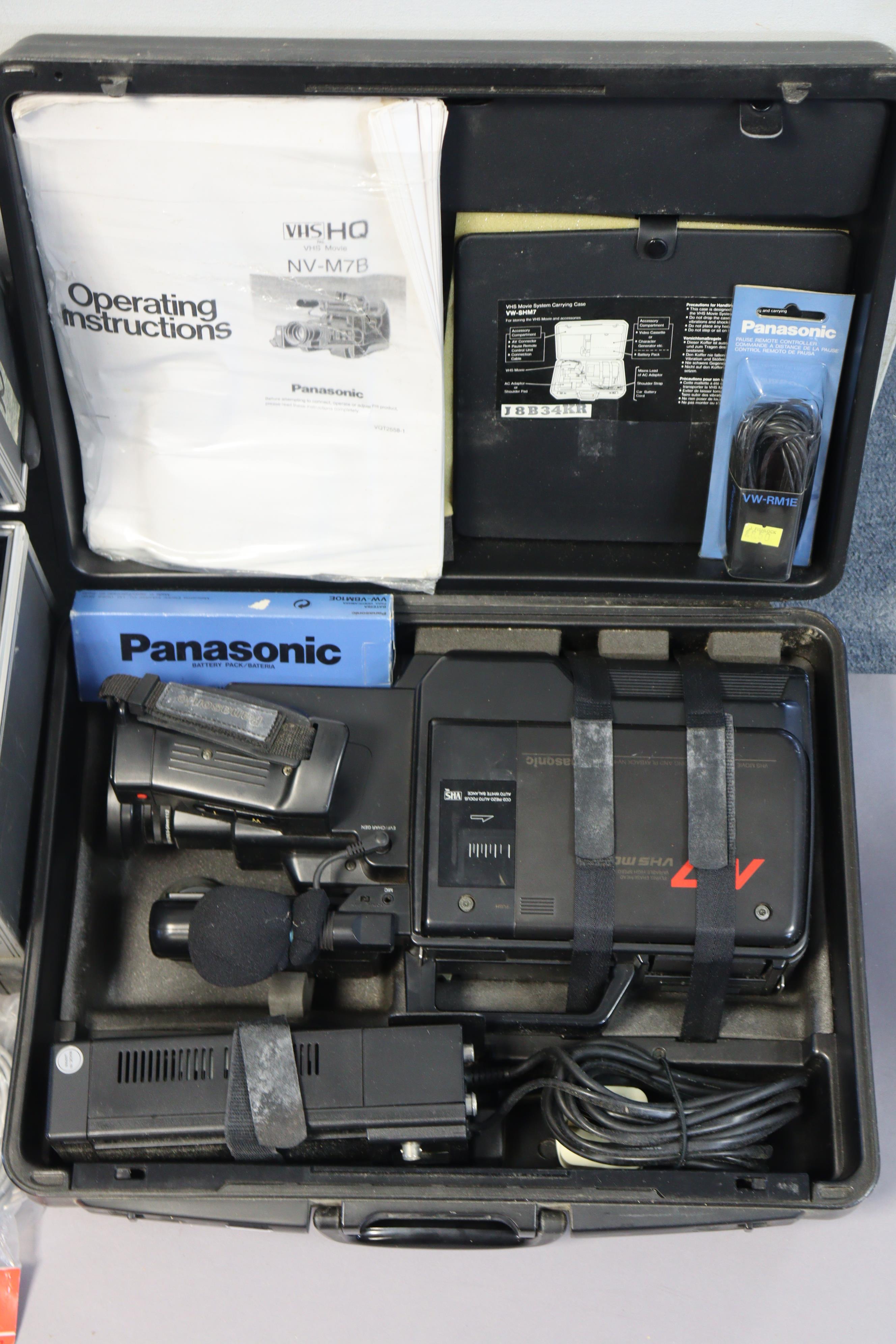 Two Panasonic VHS movie cameras, both cased, a Jaguar slide-projector, boxed, and various circular - Image 3 of 4