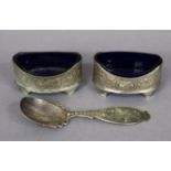 A pair of silver engraved oval salt cellars each with a blue glass liner (hallmarks rubbed), 8.