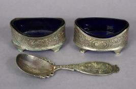 A pair of silver engraved oval salt cellars each with a blue glass liner (hallmarks rubbed), 8.