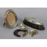 A late Victorian silver sovereign case, Birmingham 1900; a silver oval photograph frame; a silver-