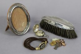 A late Victorian silver sovereign case, Birmingham 1900; a silver oval photograph frame; a silver-