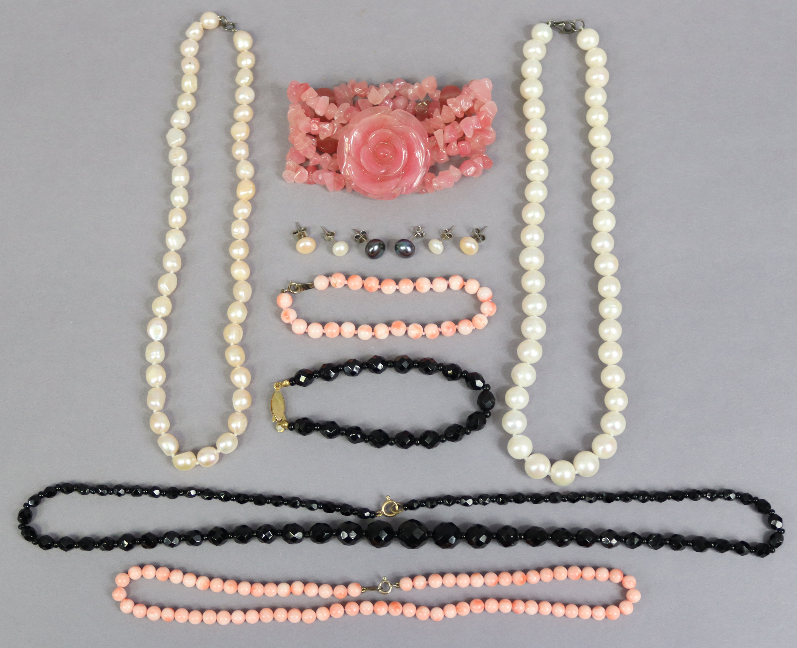 Two pearl necklaces, 43cm & 42.5cm long; a coral necklace, 40cm long; a jet necklace, 60cm long,