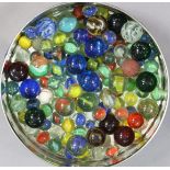 A collection of approximately eighty various glass marbles
