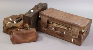 A vintage tan leather suitcase fitted brass twin-lever locks, 55.5cm wide; together with two fibre-