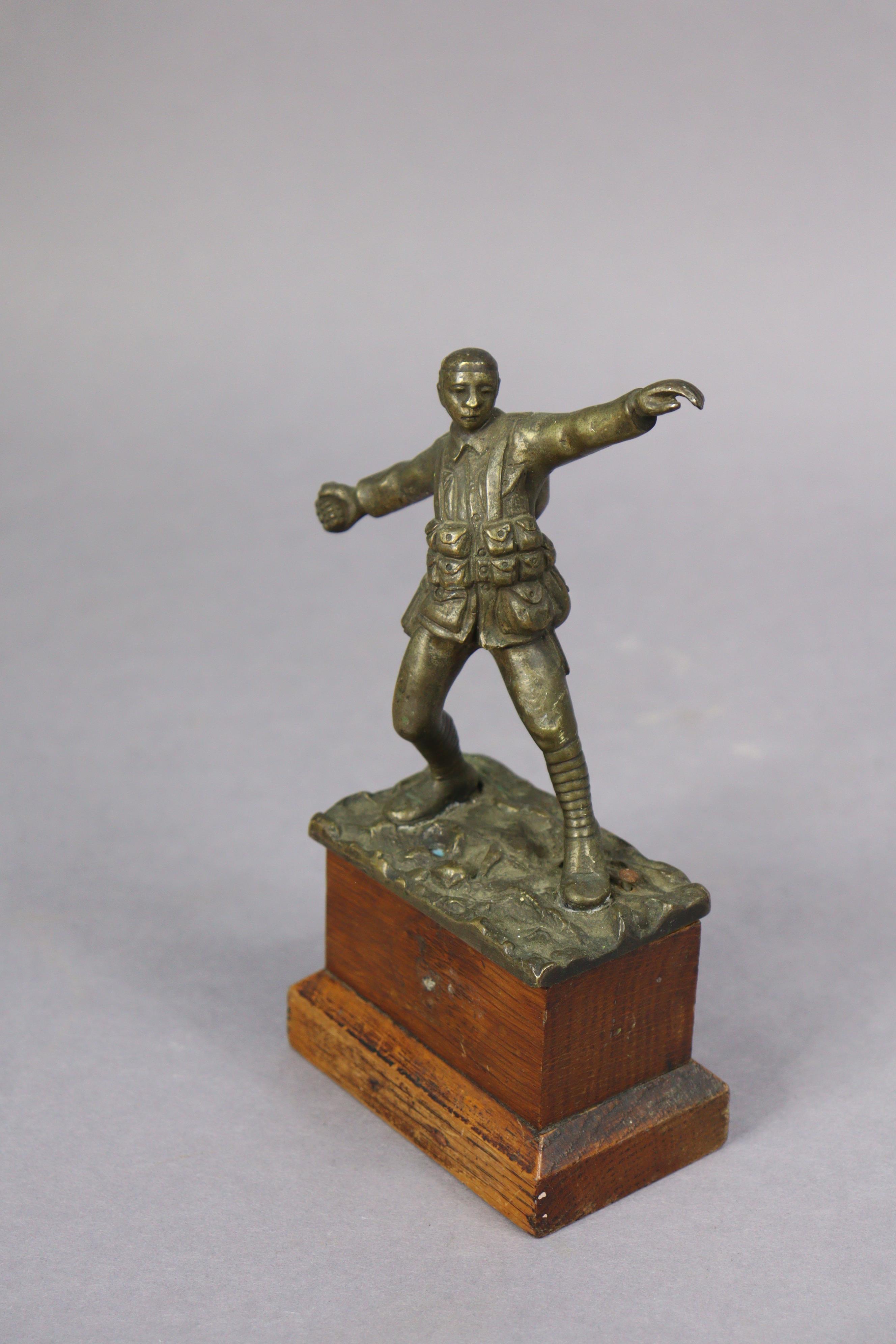 A bronzed sculpture of a WWI standing soldier figure throwing a grenade, signed to reverse “Sydney - Image 2 of 4