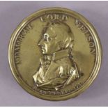 An early 19th century brass snuff box commemorating Admiral Lord Nelson, with titled portrait to the