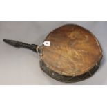 A Nepalese shaman’s drum or Dhyango having an ebonised & carved wooden handle, 44cm diameter x
