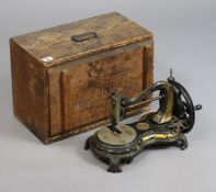 A vintage Jones serpentine cat-back sewing machine with gilt foliate decoration, 38cm wide, with