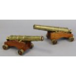 A pair of brass cannons, each inscribed “W. NORTH 1848” & with a military arrow, & each mounted on