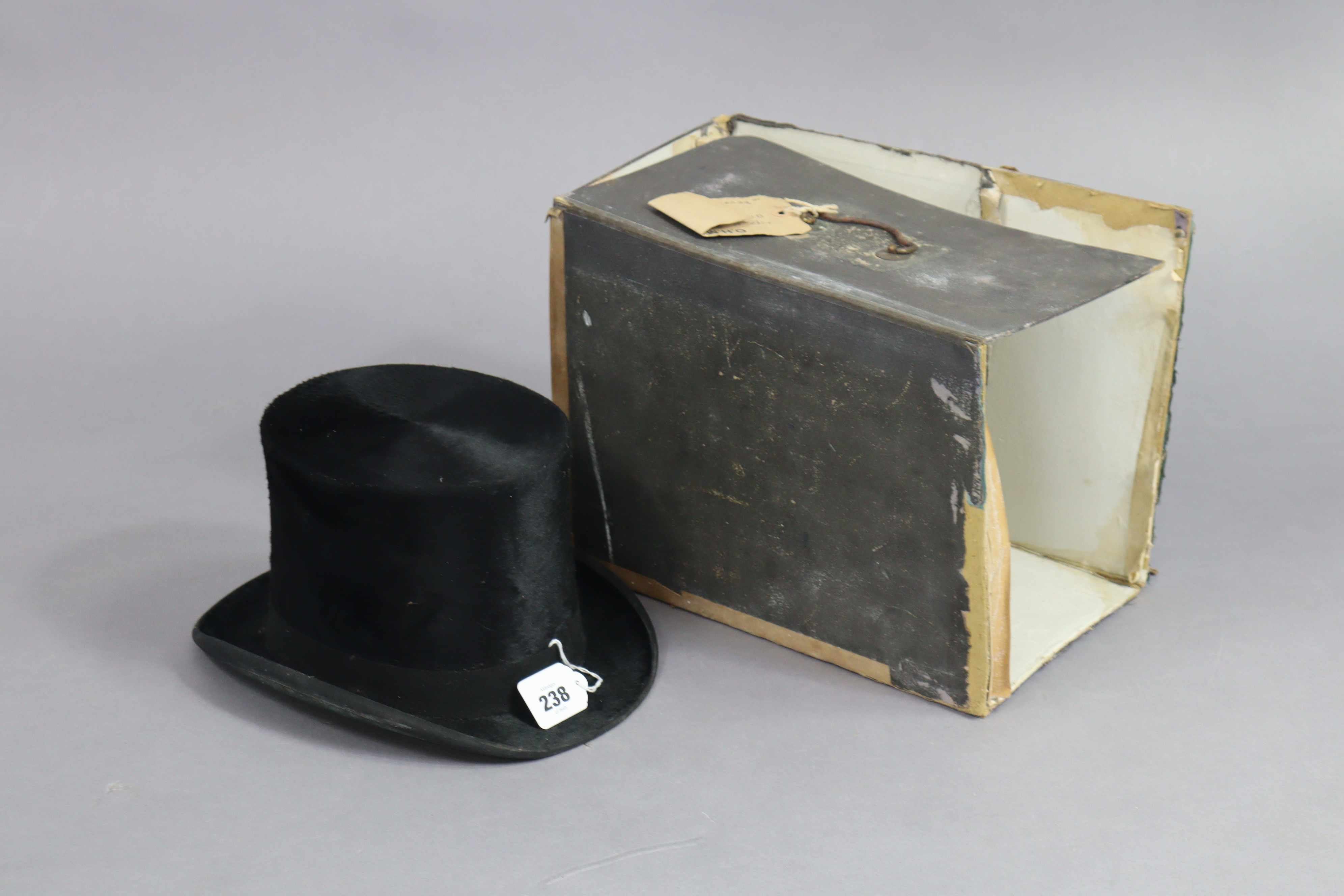 A black silk top-hat, bears label “Lincoln Bennette & Co. London”, with hatbox (hatbox w.a.f.).