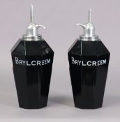 A pair of mid-20th century “BRYLCREEM” opaque-glass barber’s dispensers, 25cm high.