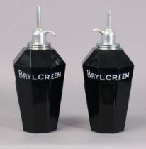 A pair of mid-20th century “BRYLCREEM” opaque-glass barber’s dispensers, 25cm high.