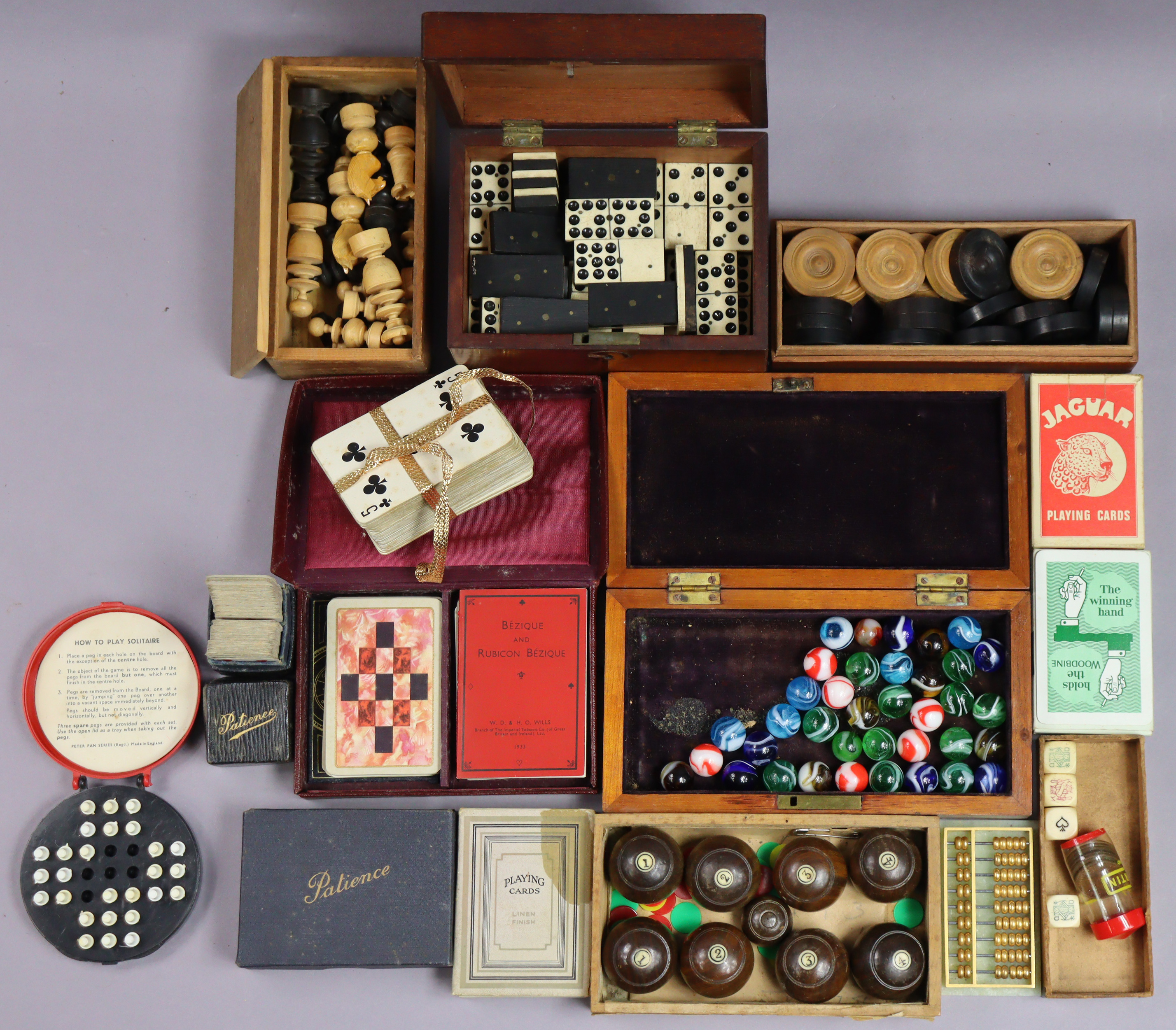 A set of carved treen travelling chessmen (size of kings 5.75cm high); a set of dominoes; a set of