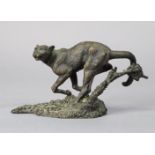A small, bronzed ornament in the form of a wild cat, signed Mene, 13cm wide x 6.75cm high.