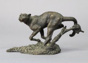 A small, bronzed ornament in the form of a wild cat, signed Mene, 13cm wide x 6.75cm high.