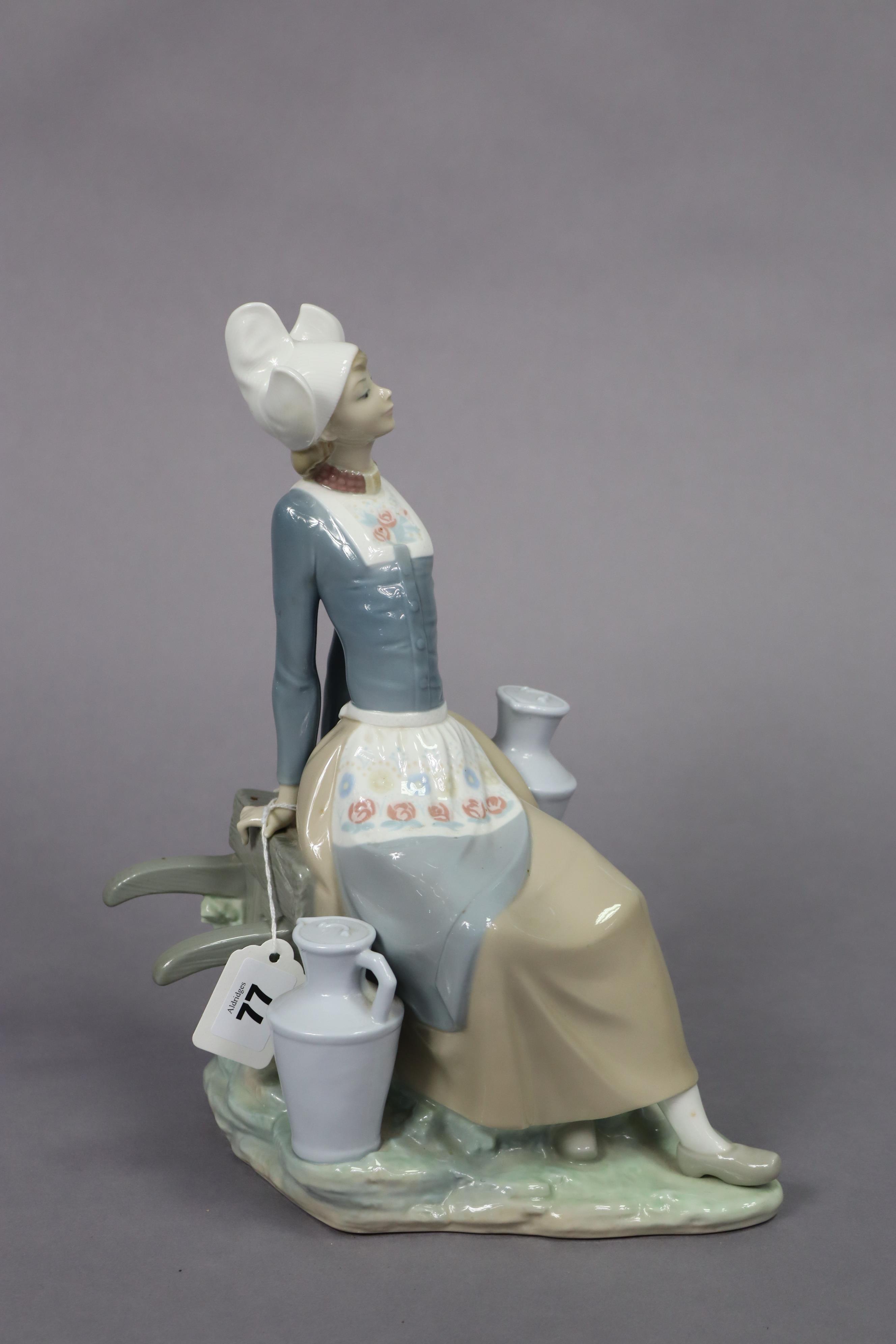 A Lladro porcelain figure of a milkmaid seated on a wheelbarrow, 32.5cm high. - Image 6 of 7