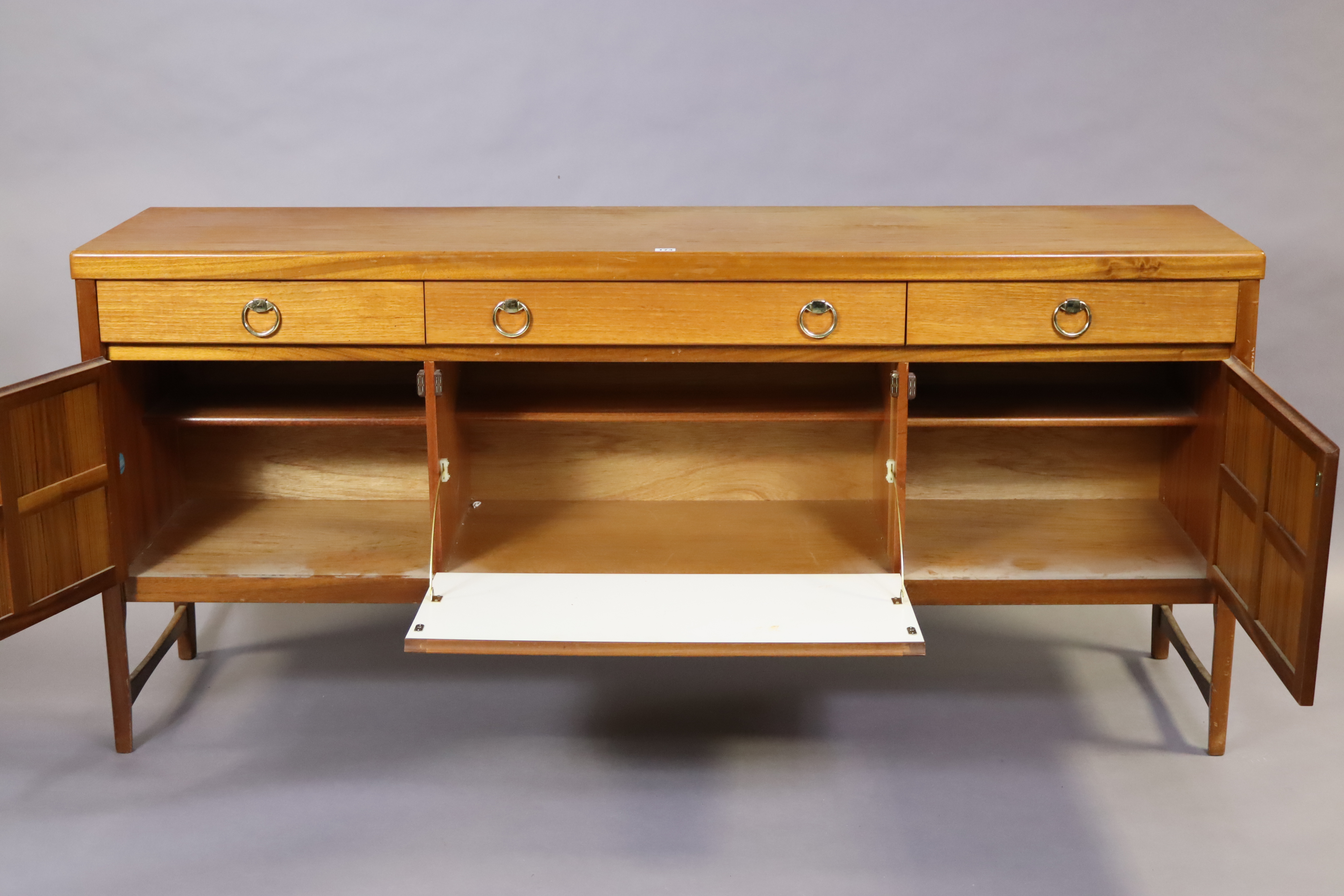 A Nathan teak sideboard fitted three frieze drawers above cupboards enclosed by a fall-front panel - Image 2 of 7