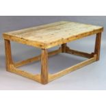 A pine farmhouse table having a four-board rectangular top, & on four square tapered legs with shape
