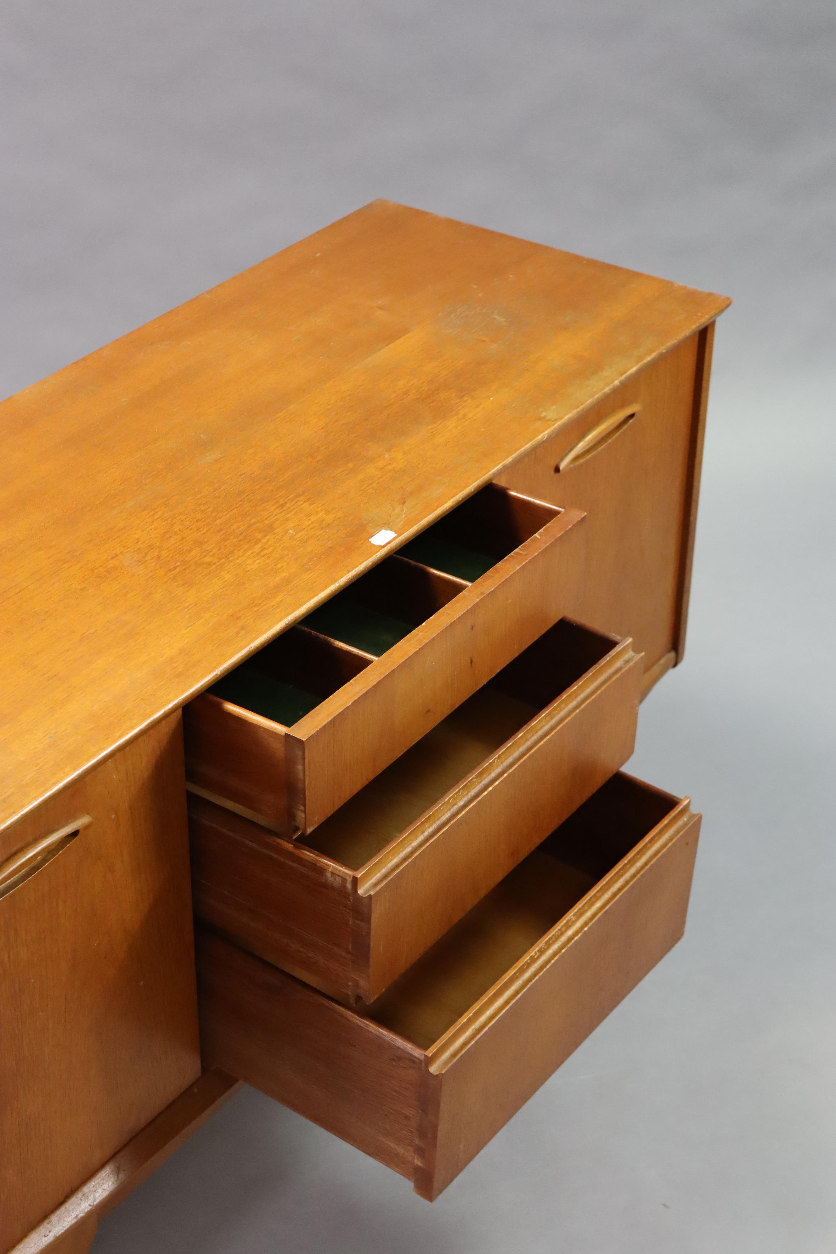 A mid-20th century teak dining room suite comprising of a circular extending table with a centre - Image 11 of 13