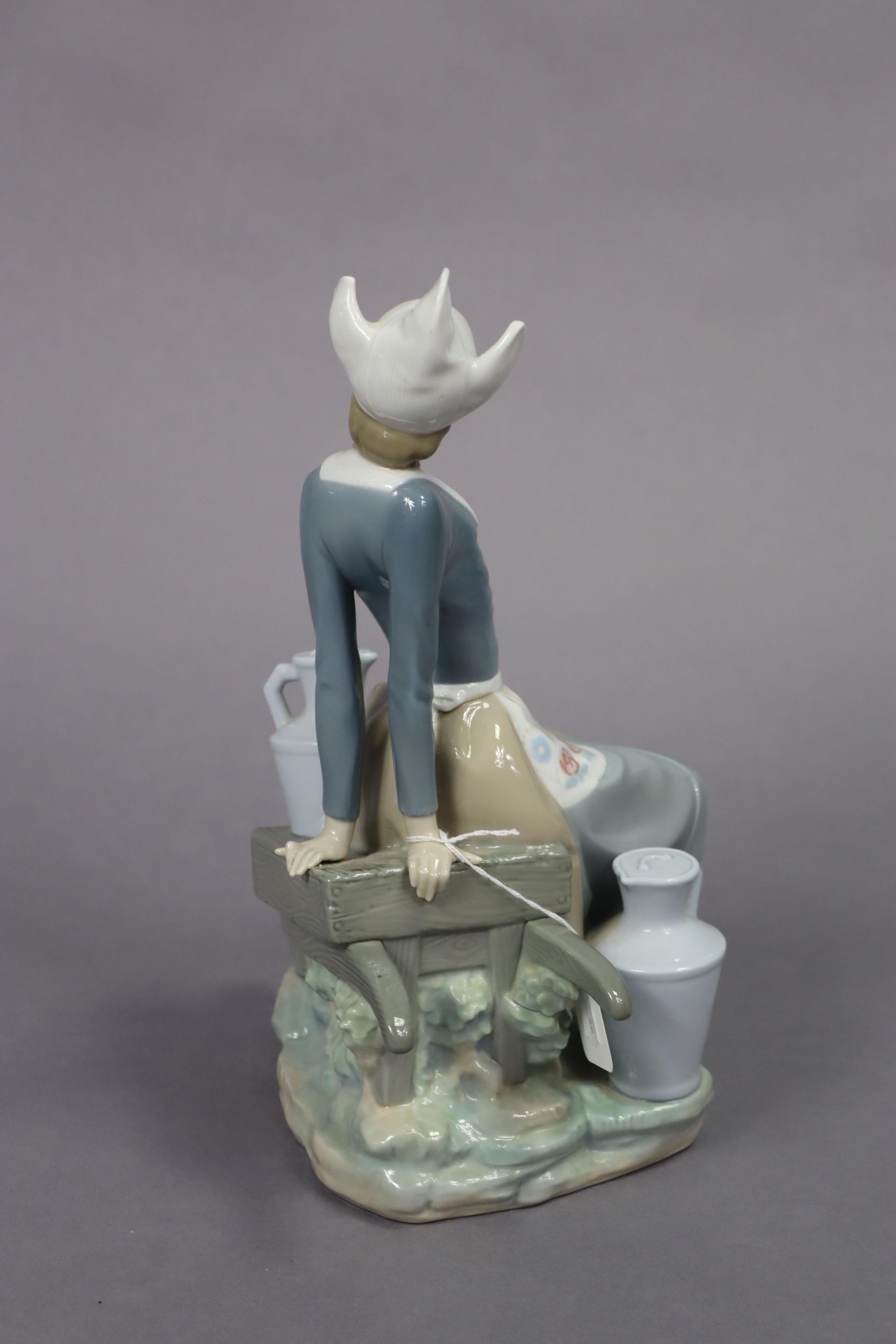 A Lladro porcelain figure of a milkmaid seated on a wheelbarrow, 32.5cm high. - Image 5 of 7
