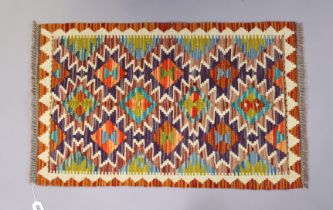 A Chobi Kilim rug of multi-coloured geometric design 94cm x 59cm.