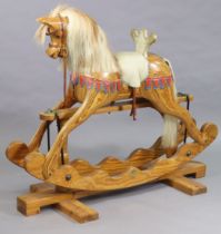 A pine rocking horse with a horse-hair mane & tail, & on a trestle base, bears label “Ian Armstrong,