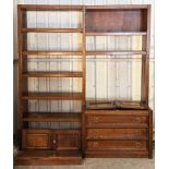 A mahogany-finish tall wall unit fitted with an arrangement of drawers, cupboards & open shelves,