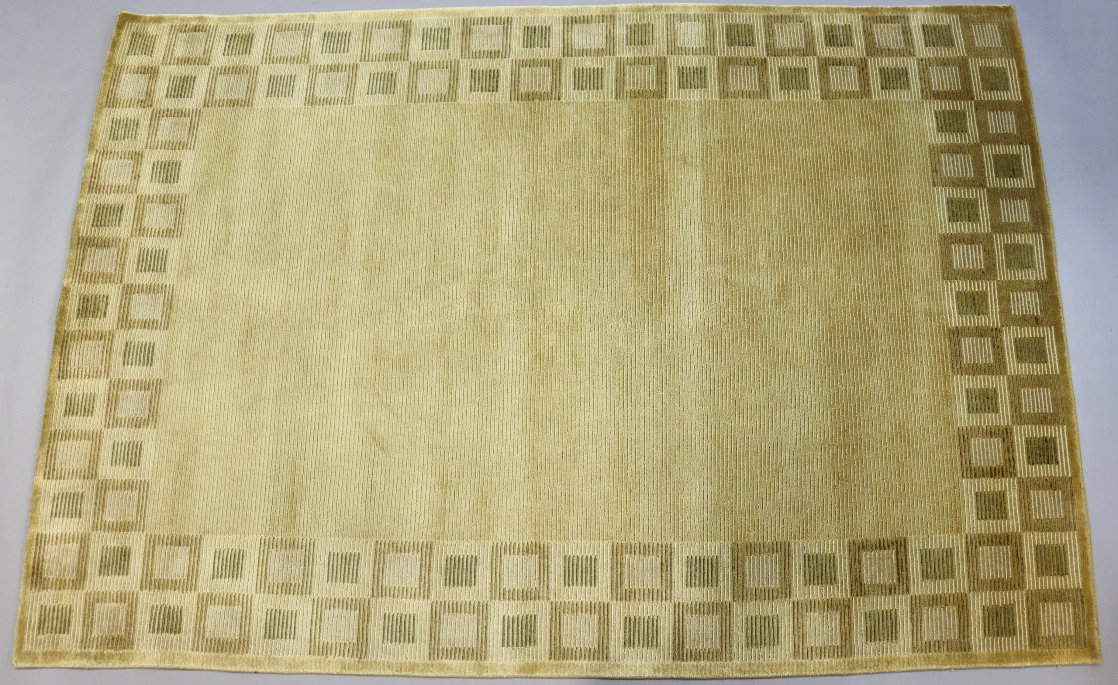 An Indian wool rug of gold ground with geometric pattern, 244cm x 168cm (purchased from