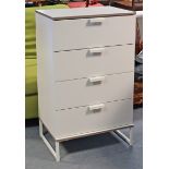 A white-finish upright chest fitted four long drawers, & on short square legs with plain stretchers,